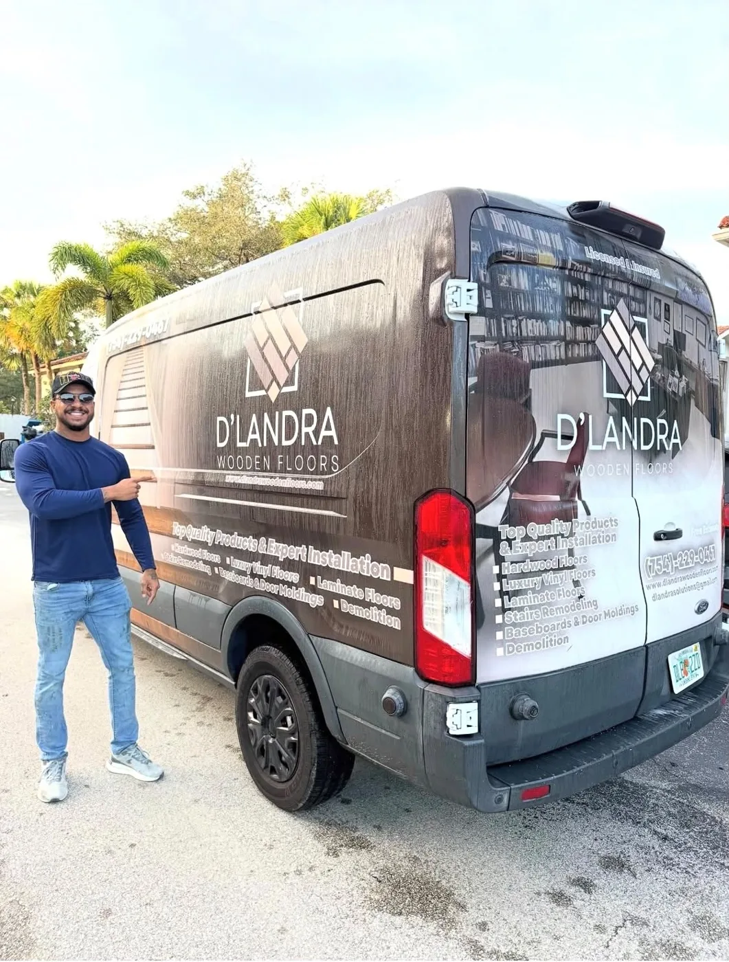 Alex Landra beside the D'Landra Wooden Floors work van in Coral Springs